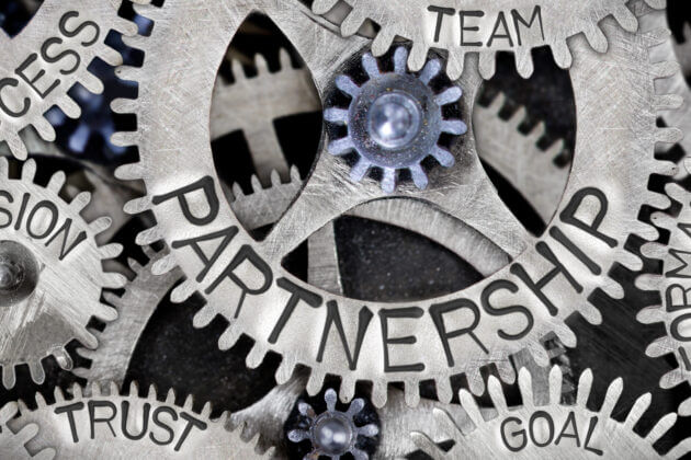 Cogs inscribed with the words success, vision, partnership, team, goal, trust, performance