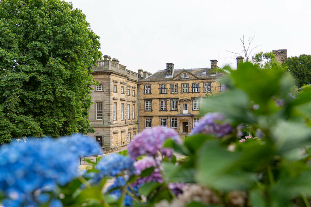 exterior view of Northern College with foliage in the foreground